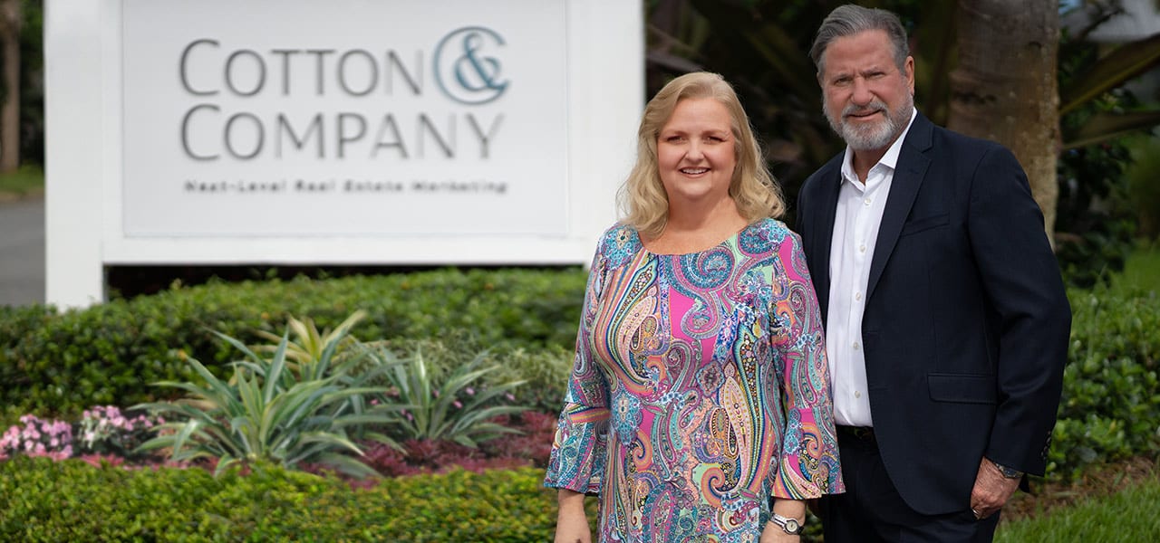 Laurie Andrews and Stephann Cotton in front of the Cotton & Company signage